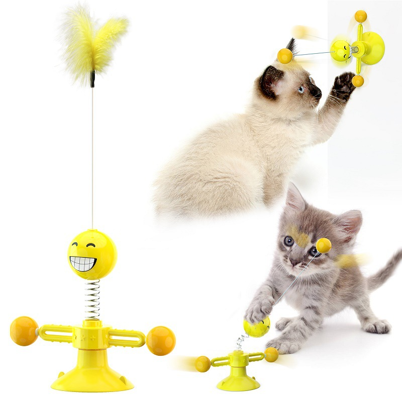 Yellow cat toy with feather and spinning balls for interactive kitten play and exercise