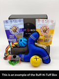 Dog toys and treats in Ruff-N-Tuff Box, including chew toys, rope, and probiotic snacks for pets.