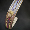 Luxury dog collar with gold spikes, colorful gems, and BESTIA branding, perfect for stylish pets.