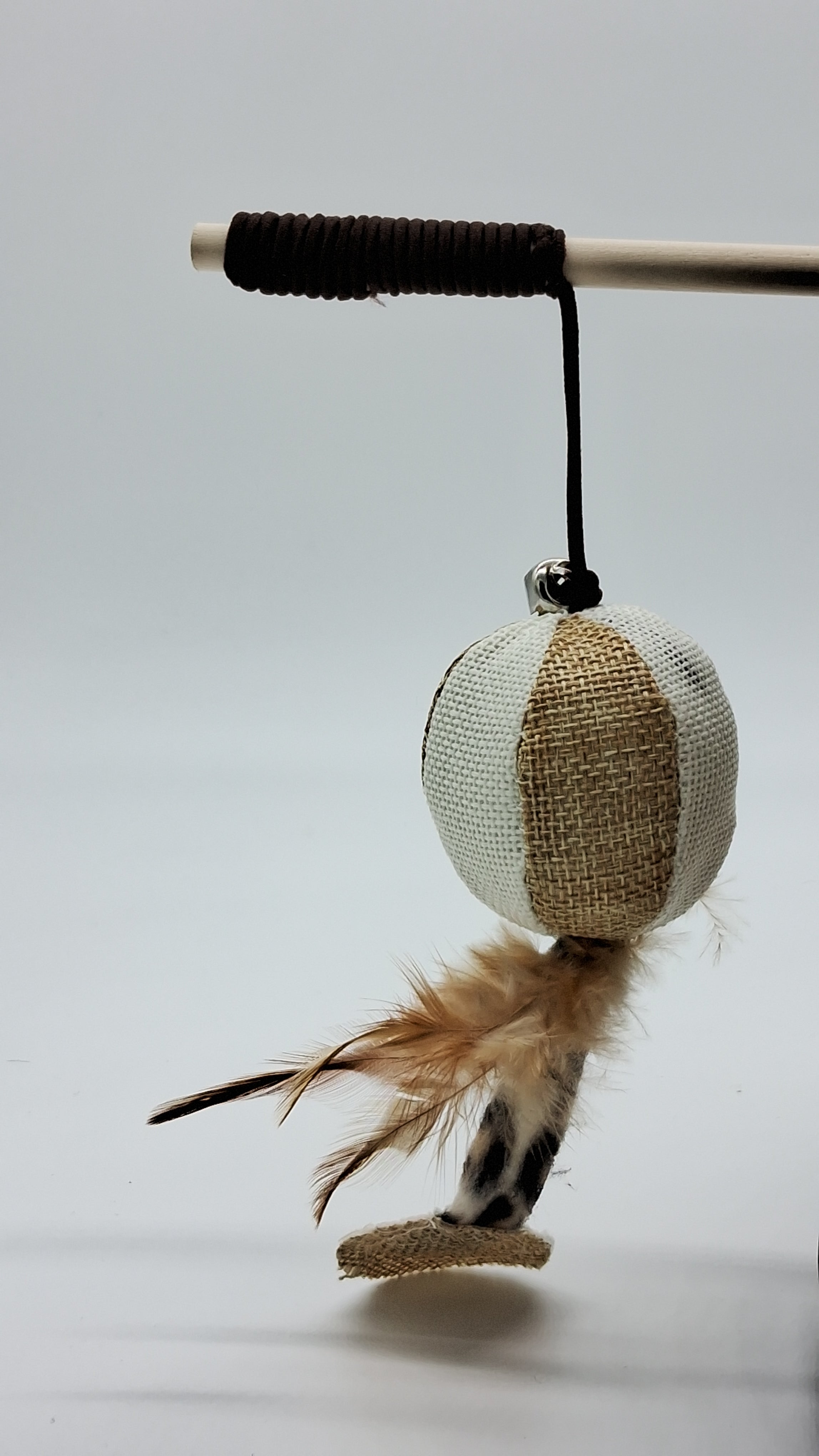 Cat wand toy with burlap ball, feathers, and bell for interactive pet play