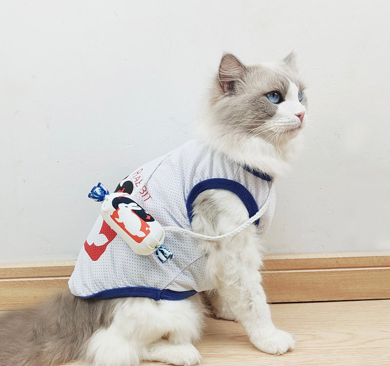 Fluffy cat in white mesh vest with penguin-themed treat pouch, perfect for pet accessories and playful outings.