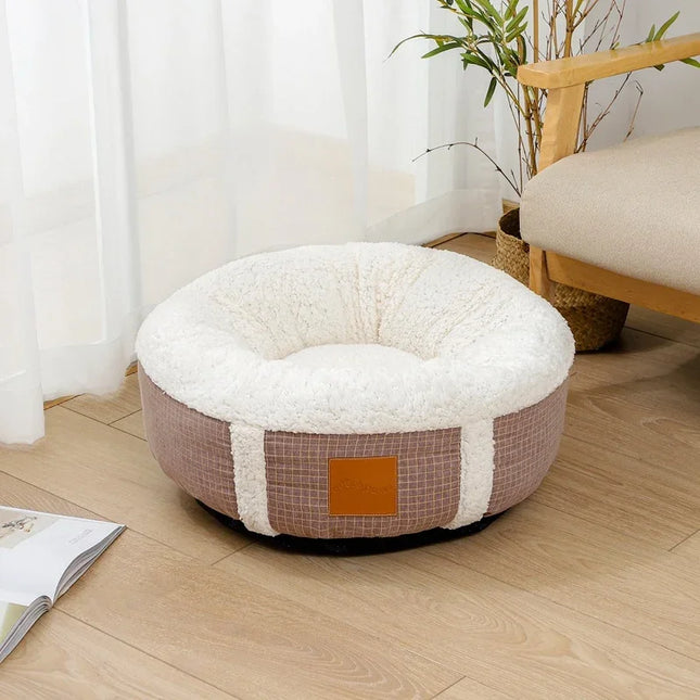 Cozy round pet bed with plush white interior and brown checkered exterior, perfect for dogs or cats.