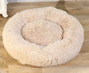 Plush round pet bed for dogs and cats, cozy soft fur design on wooden floor