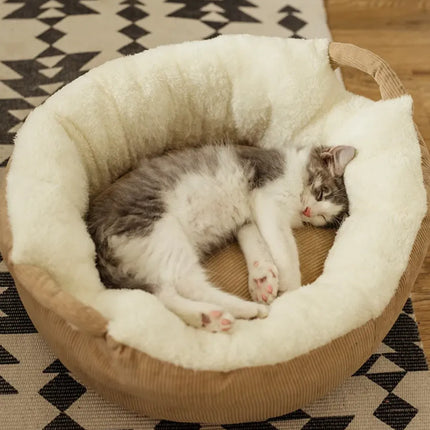 A grey and white cat sleeping in a plush Nai Pet Store pet nest bed.