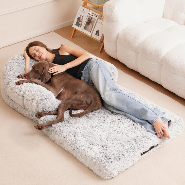 Cozy gray plush dog bed with woman and brown dog resting together, perfect for pet comfort and bonding.