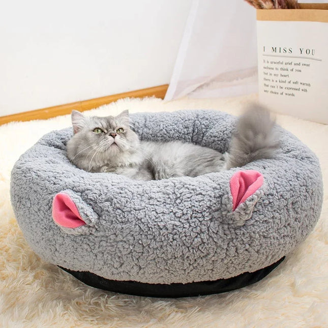 Fluffy gray cat resting in cozy gray pet bed with pink ears, perfect for cats and small dogs.