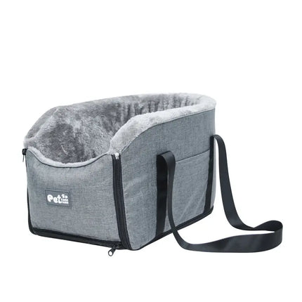Grey center console pet travel bed with soft faux fur lining and carrying strap.