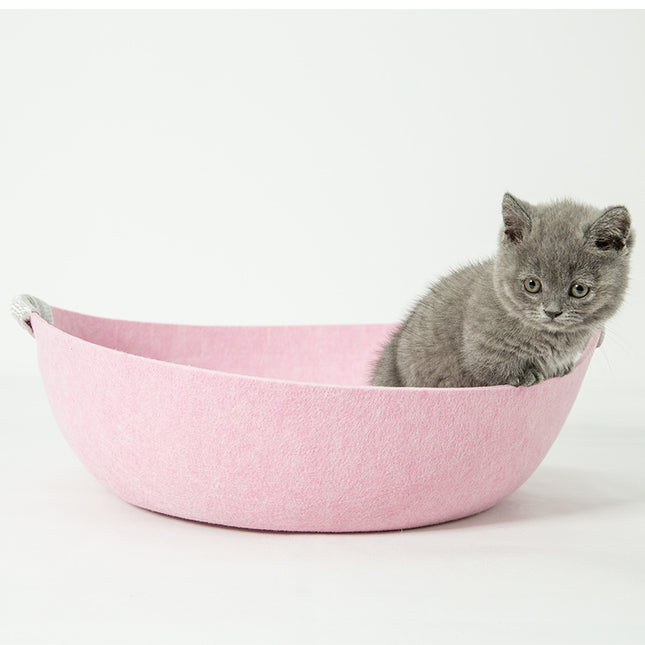 Gray kitten in pink felt cat bed, cozy pet accessory for cats