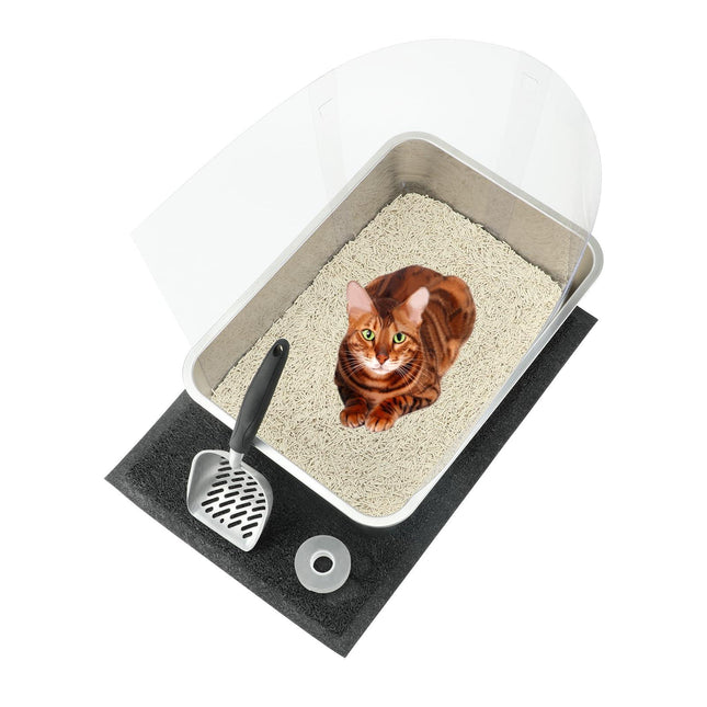 Cat in covered litter box with scoop and mat for pet care essentials