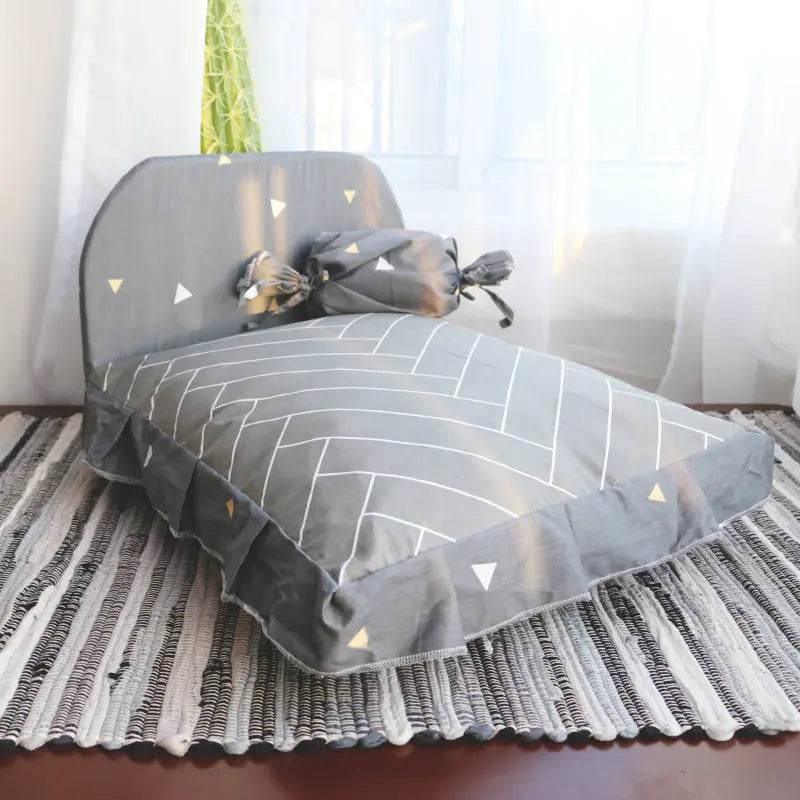 Gray pet bed with white geometric pattern, ruffled edges, and triangle accents for dogs or cats