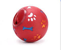 Red dog treat ball toy with paw prints and bones for interactive play and training