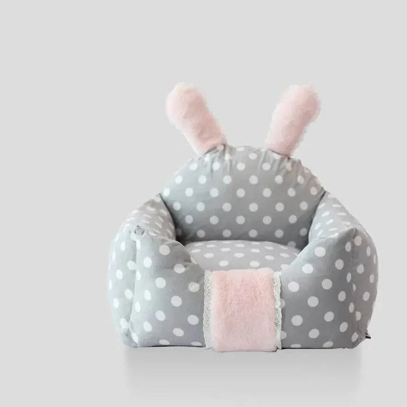 Gray polka dot pet bed with pink bunny ears and soft fleece lining for cats or small dogs