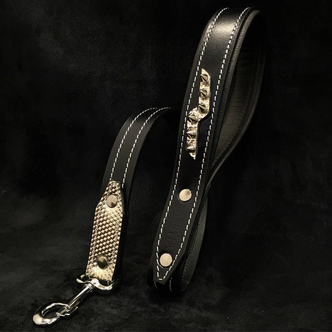 Stylish black leather dog leash with white stitching, metal spikes, and carbon fiber handle for pets