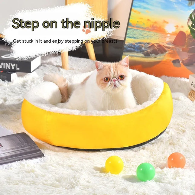 Fluffy cat in cozy yellow banana-shaped pet bed with colorful balls, perfect for cat comfort and play