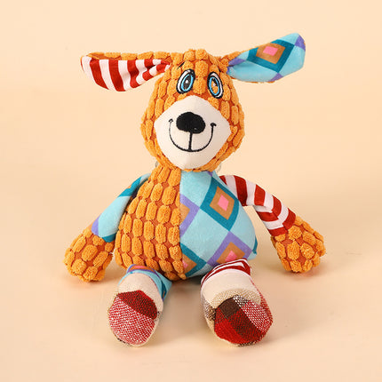 Colorful patchwork plush dog toy with patterned ears and textured orange fabric.