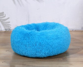 Fluffy blue pet bed for cats and dogs, cozy plush design on wooden floor