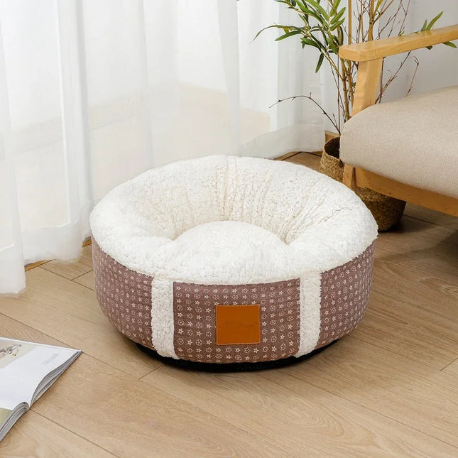 Cozy round pet bed with soft white fleece interior and patterned brown exterior, perfect for dogs or cats.