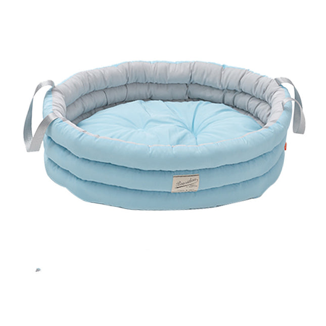 Soft blue pet bed with gray rim and handles, cozy cushion for dogs or cats