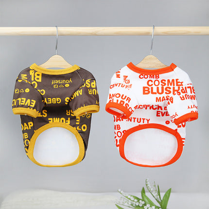 Two patterned pet clothing shirts, one brown and one white with orange text, hanging on a rack.