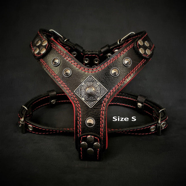 Black leather dog harness with red stitching, metal studs, and decorative emblem, Size S